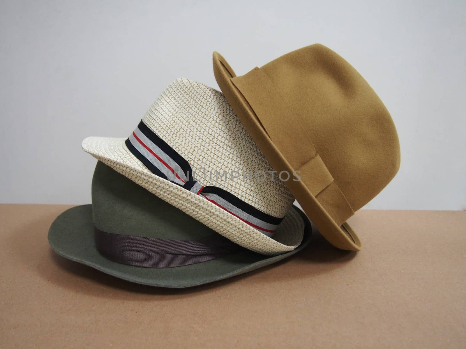 three colored men's hats. on a white background