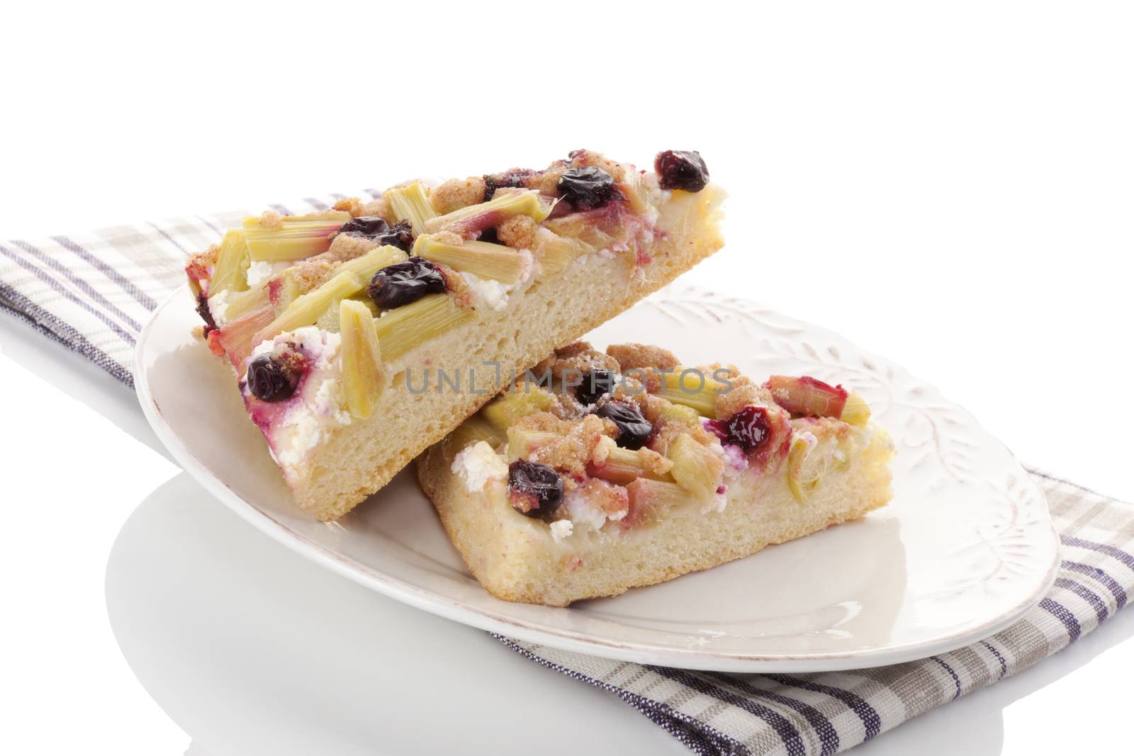 Traditional rhubarb cake on white plate isolated on white background. Culinary sweet dessert eating. 