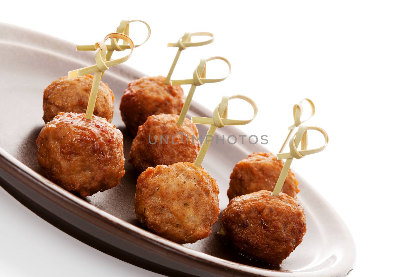 Meatballs canape on ceramic tray isolated on white background. Culinary bbq eating. 