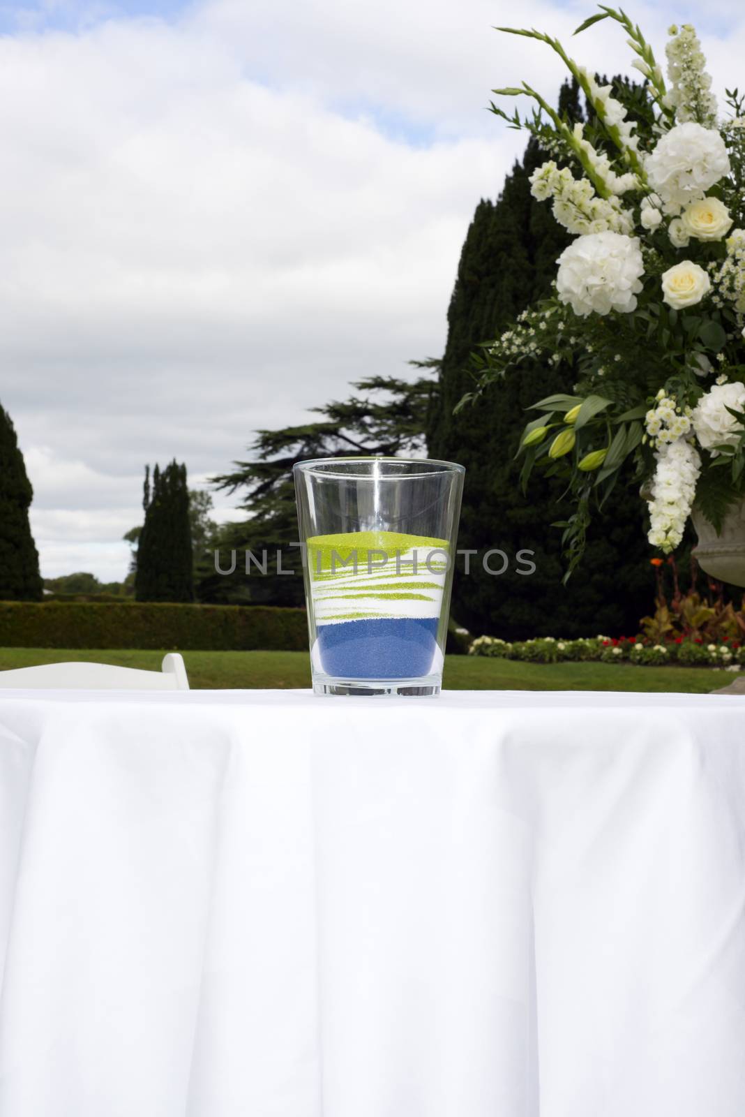 glass of mixed colour sands after a unity wedding celebration