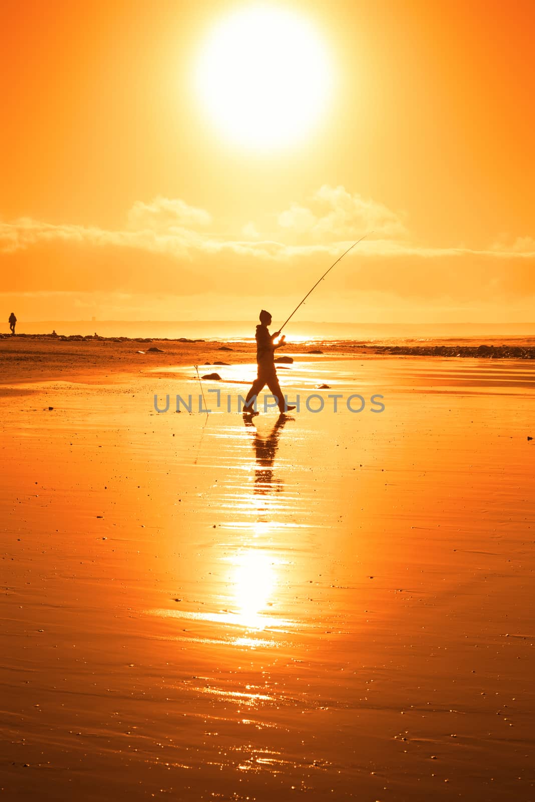 lone fisherman fishing on the beach in Ballybunion county Kerry Ireland