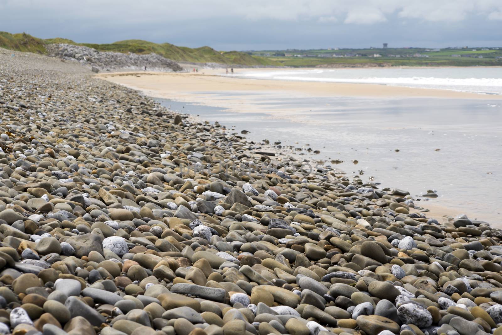 pebbled ballybunion beach beside the links by morrbyte