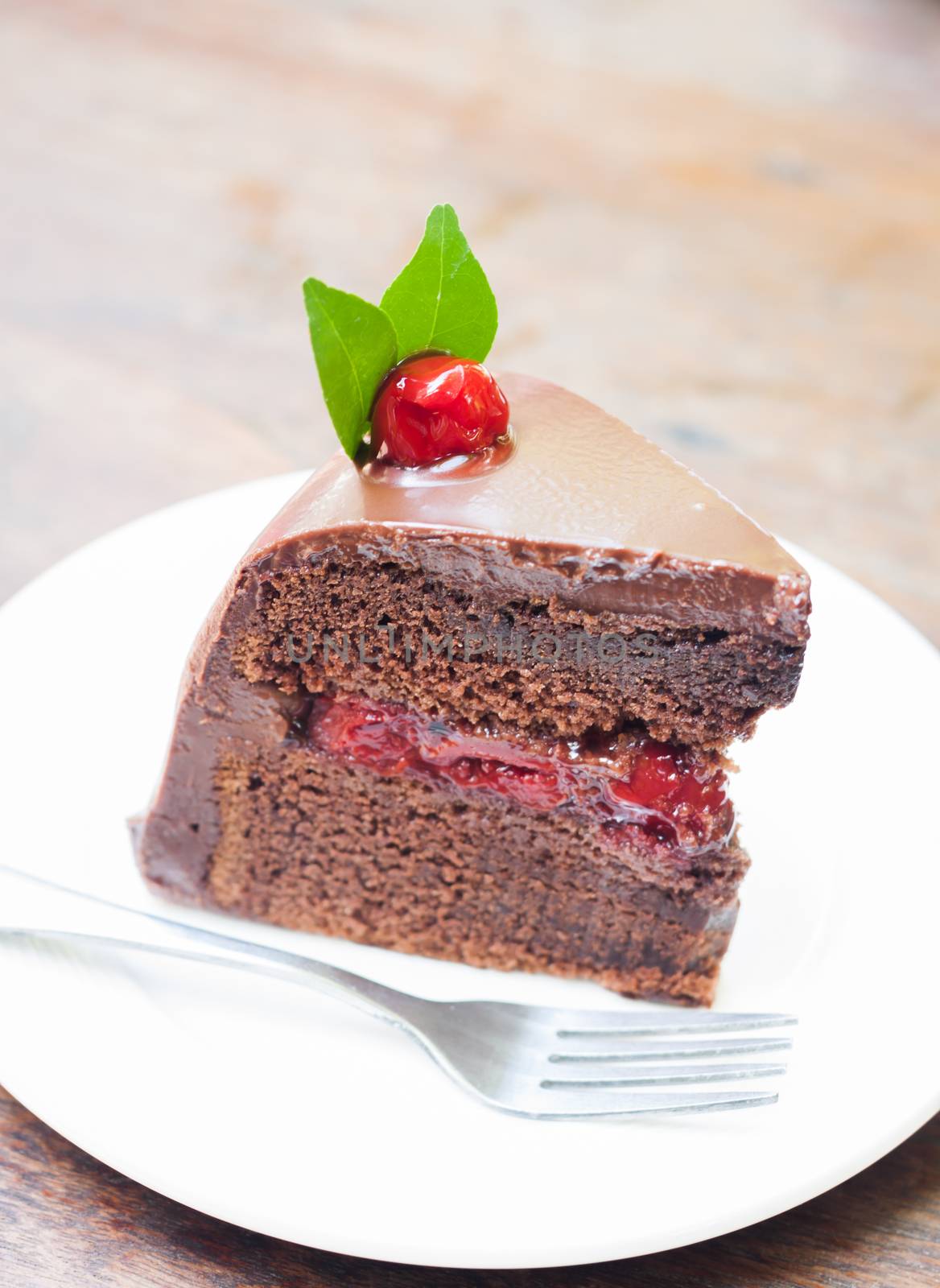 Piece of chocolate cake on white plate, stock photo