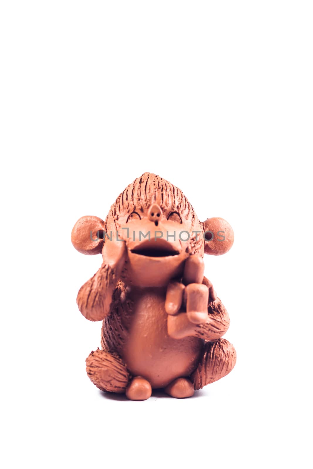 Close-up monkey clay doll isolated on white background by punsayaporn