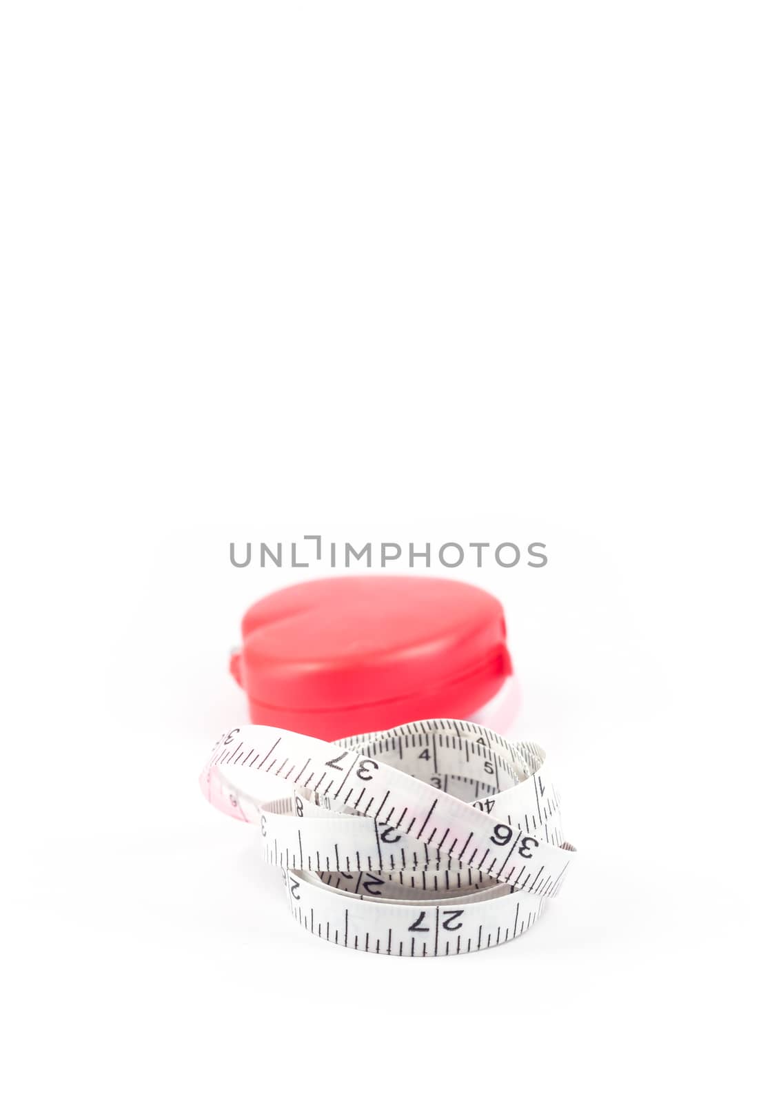 Measuring tape in heart shape on white background, stock photo