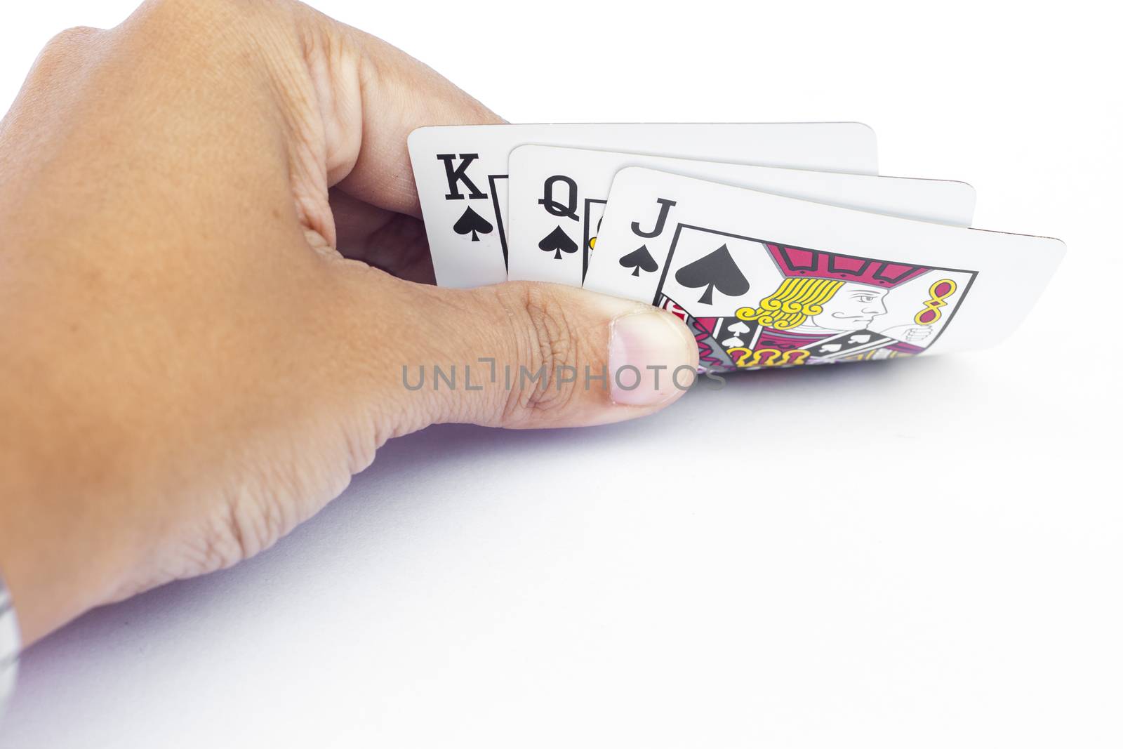 Playing cards in hand isolated on white background, stock photo