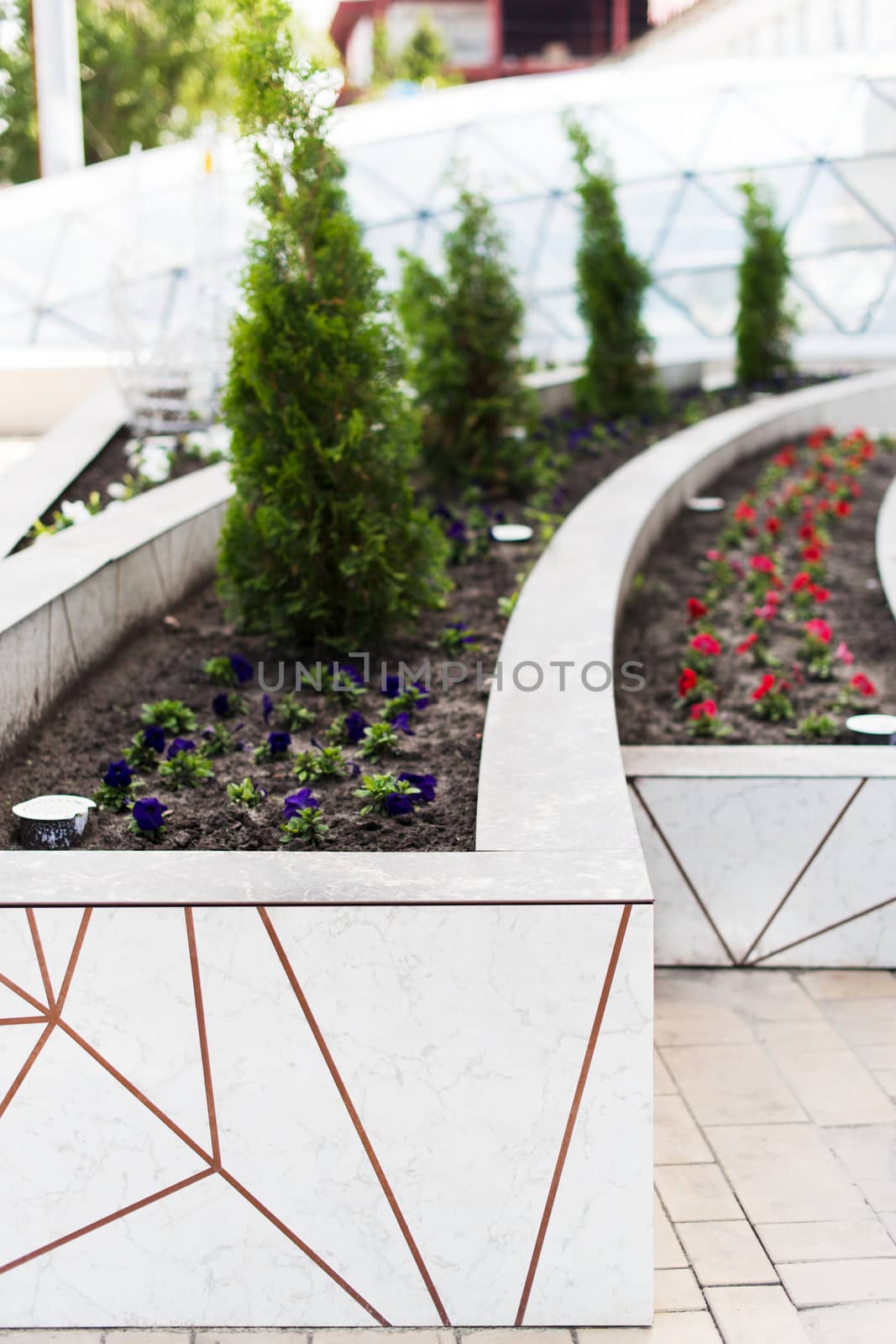 Facade flowerbeds decorated modern building panels, selective focus
