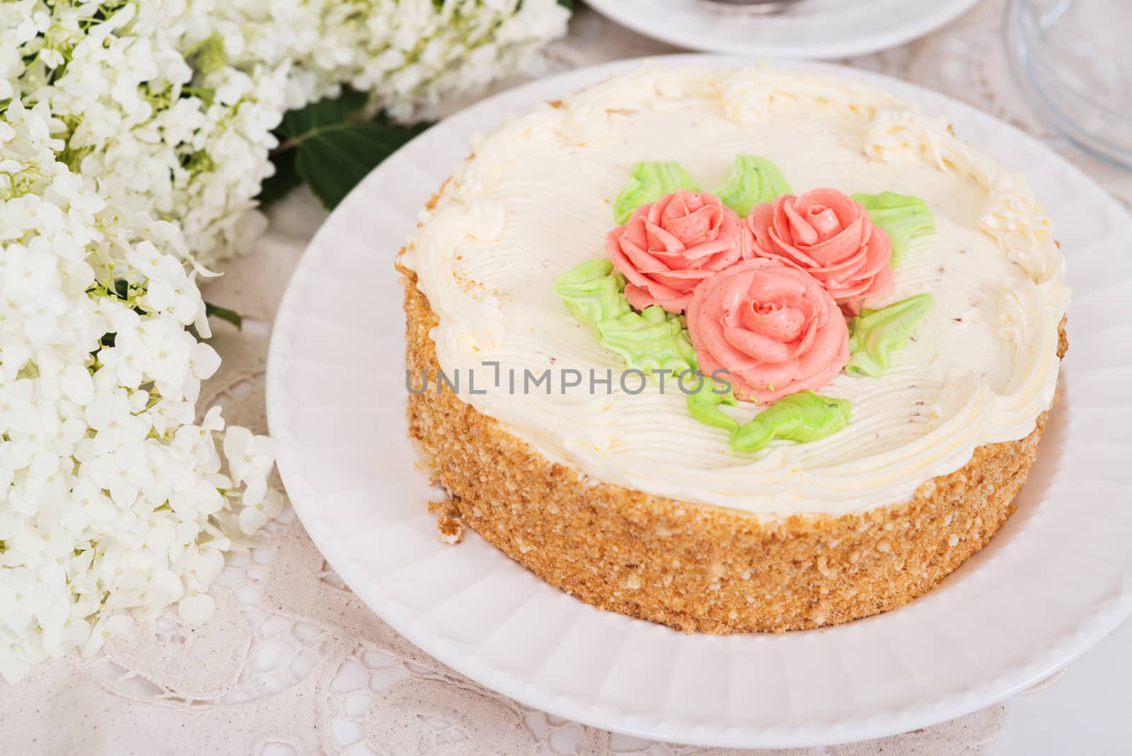 Creamy cake on plate on table on light background by kzen