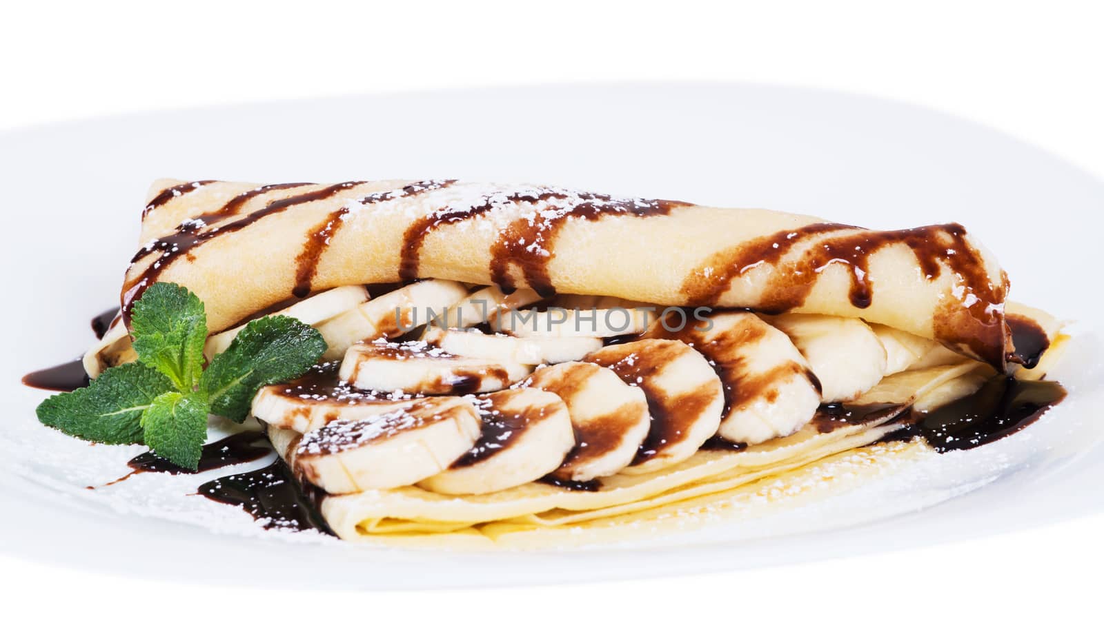 Pancakes stuffed bananas and chocolate on a plate by kzen