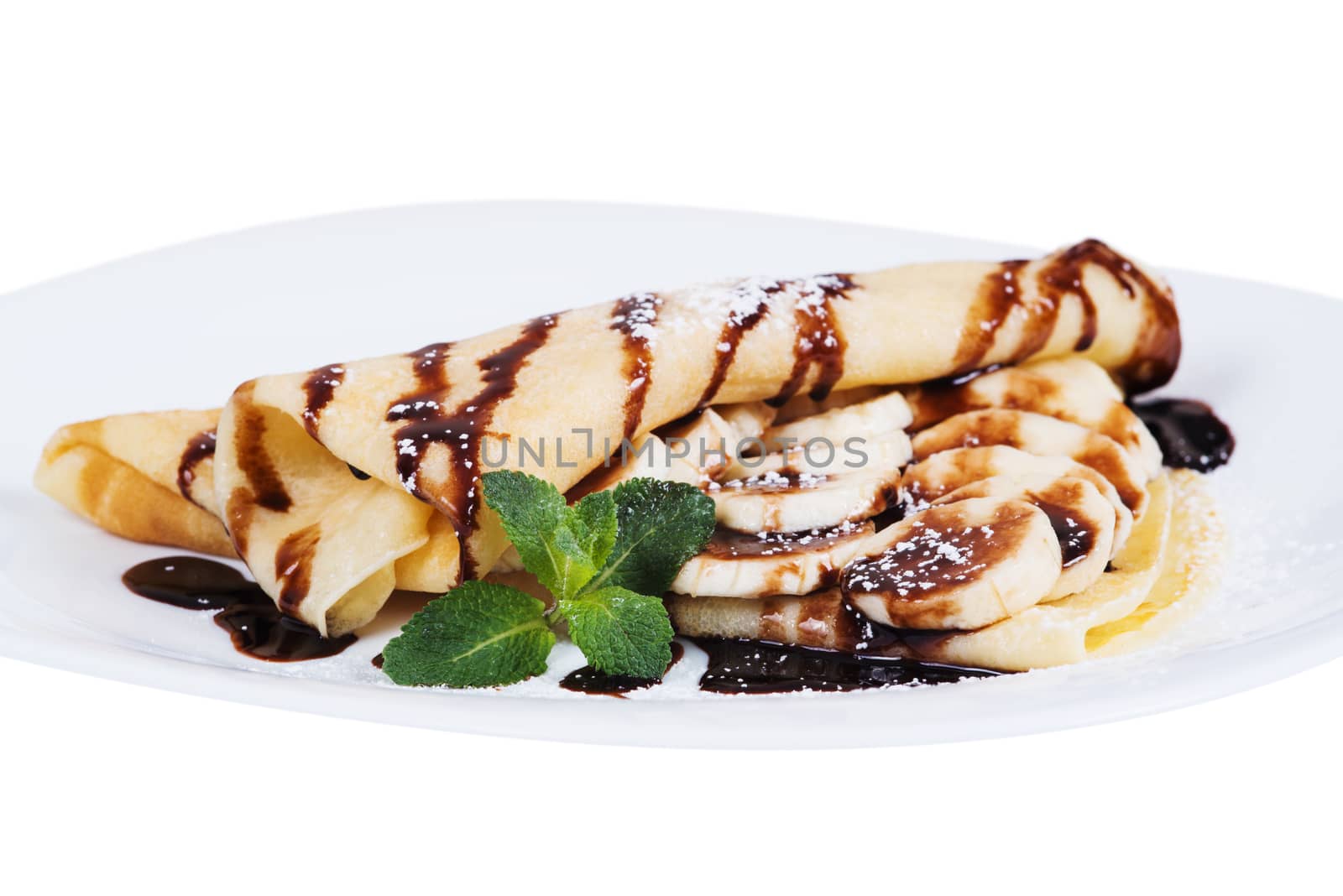 Pancakes stuffed bananas and chocolate on a plate, isolated