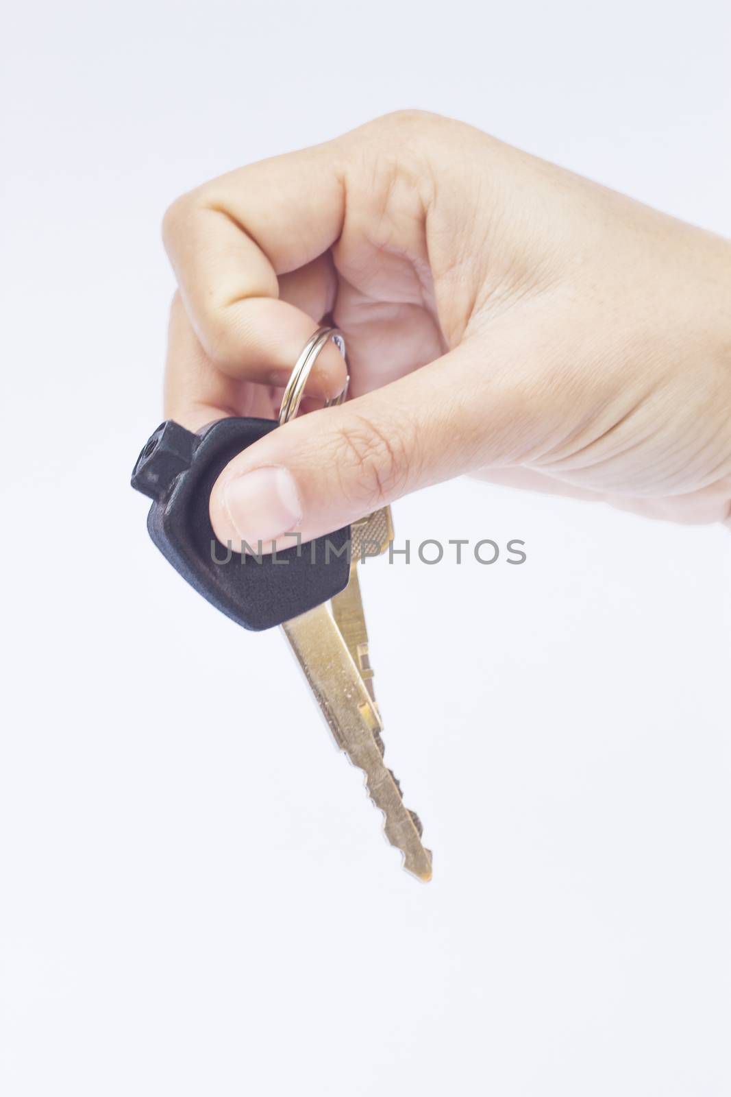 Hand with a car key isolated on white background by punsayaporn