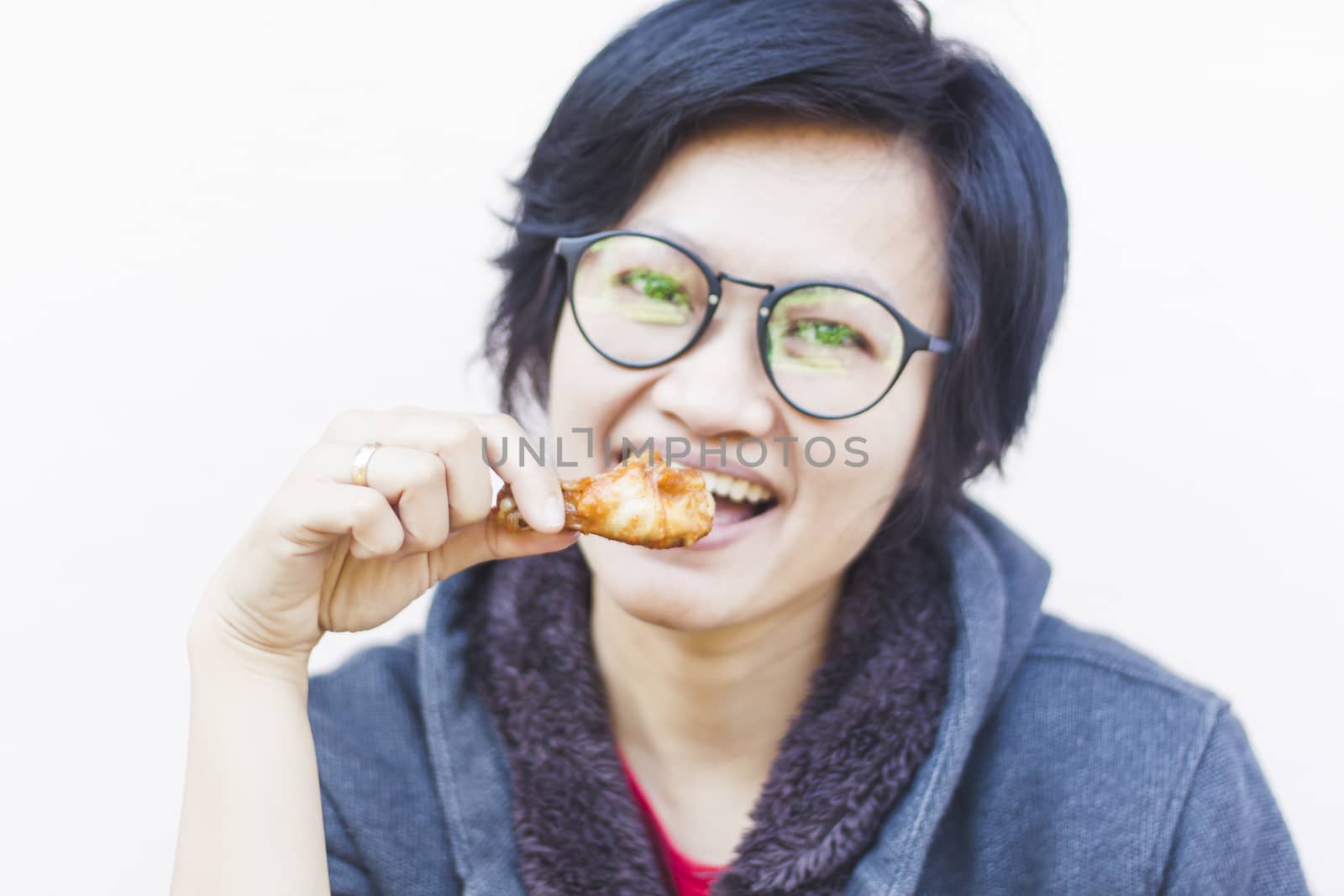 Asian woman eating delicious chicken, stock photo