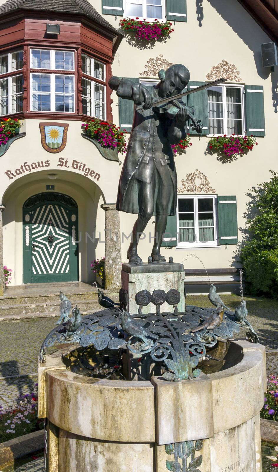 Statue of young Wolfgang Amadeus Mozart in front of townhall on Mozartplatz in St. Gilgen, Austria
