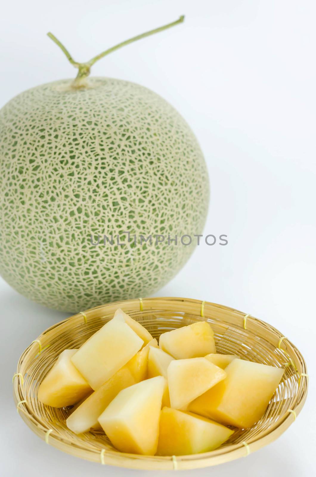 freshly cut cantaloupe melon on white background