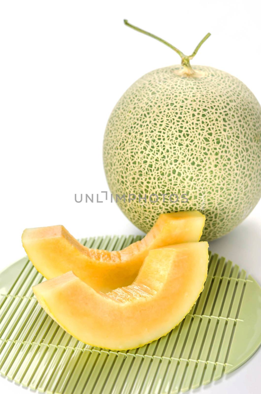 freshly cut cantaloupe melon on white background