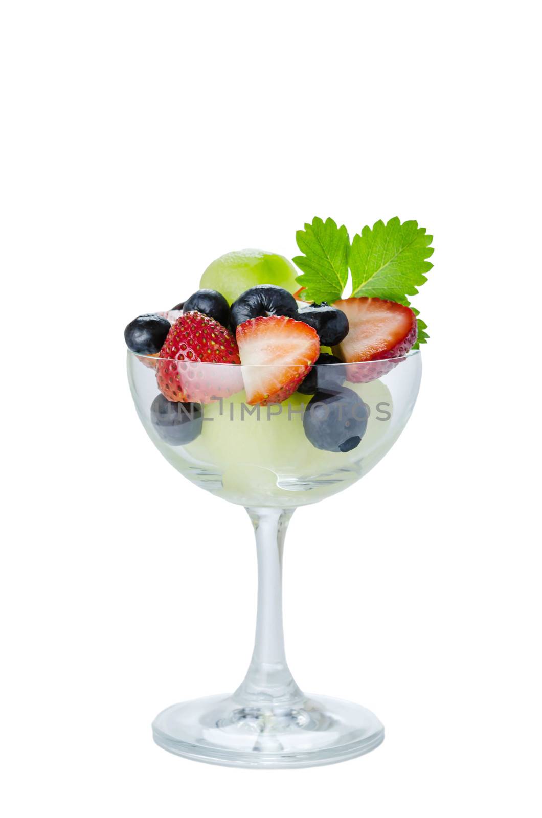 Fresh forest berries and melon  in a glass on a white background isolated