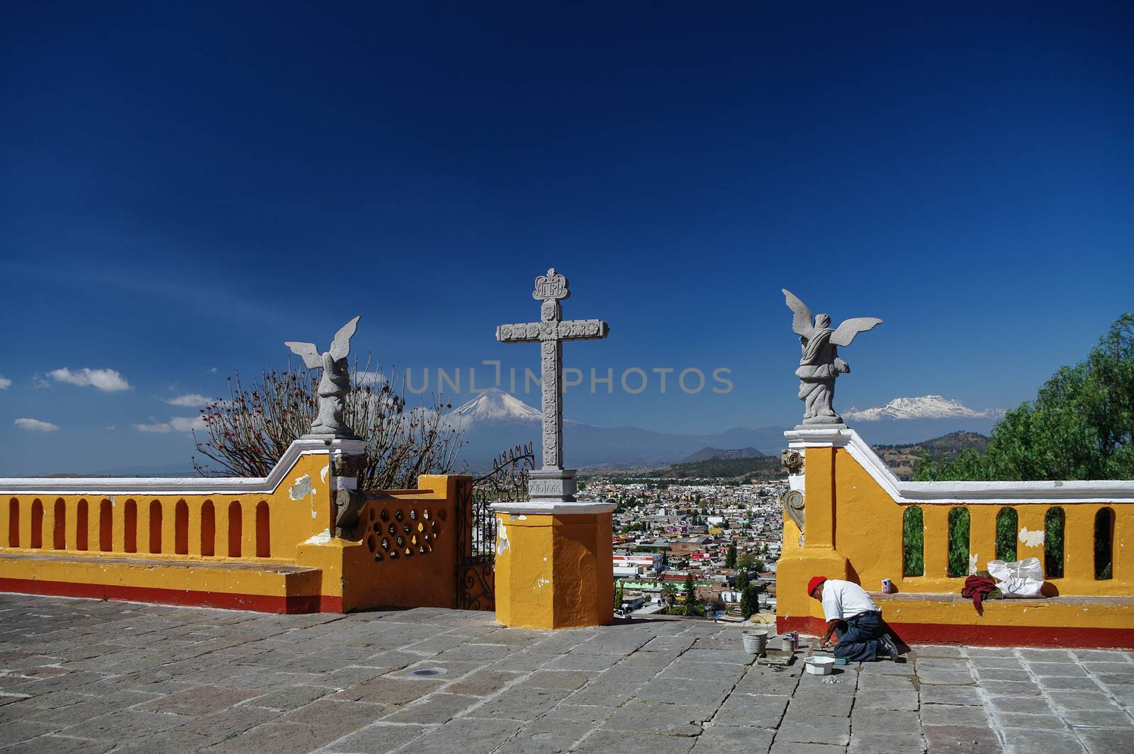 Puebla, Mexico - January 20, 2010: Church of Our Lady of Remedies on top of the Cholula Pyramid in Puebla, Mexico. Aerial view of the city and Popocatepetl volcano