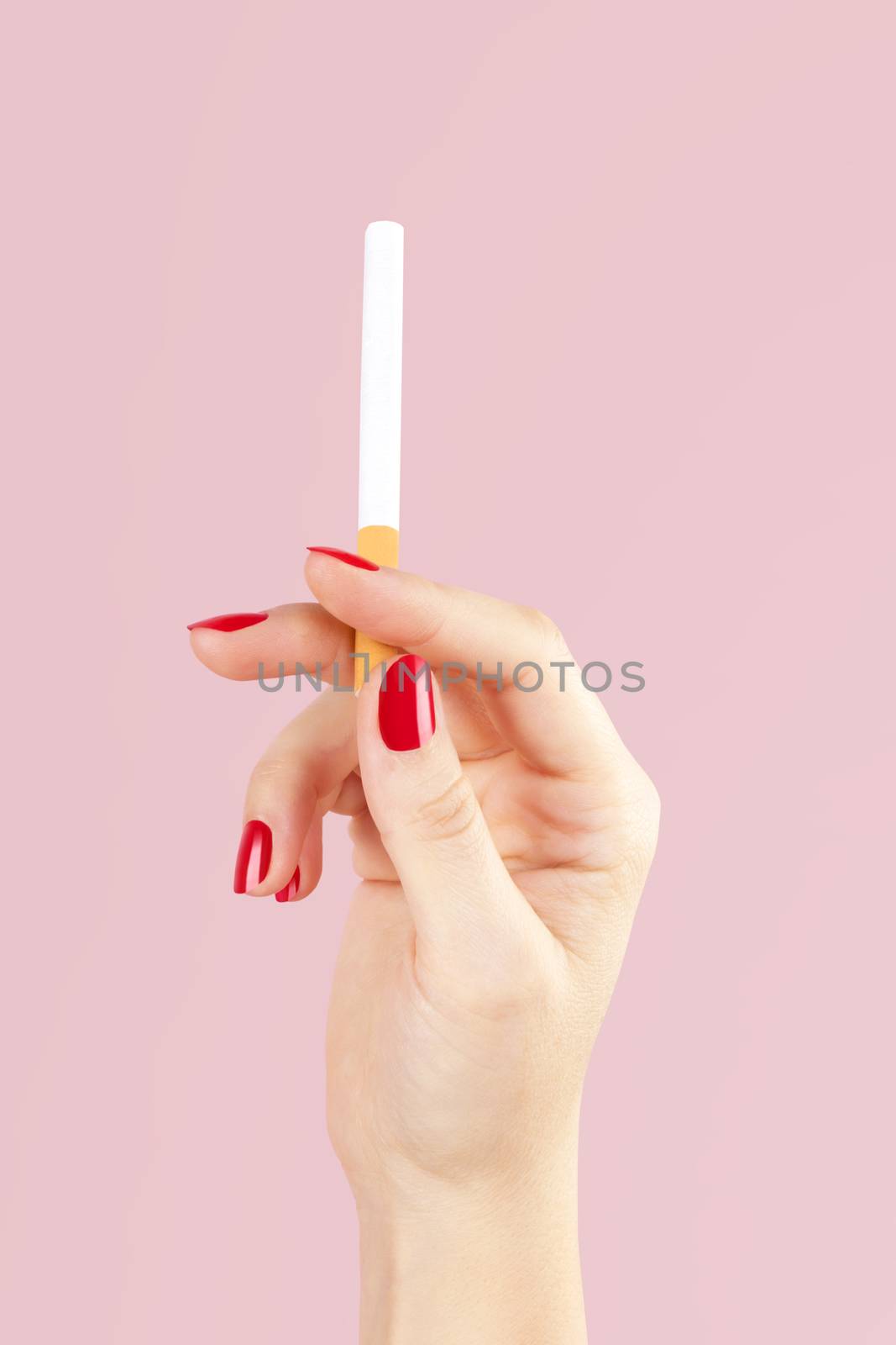 Female hand holding cigarette. by eskymaks