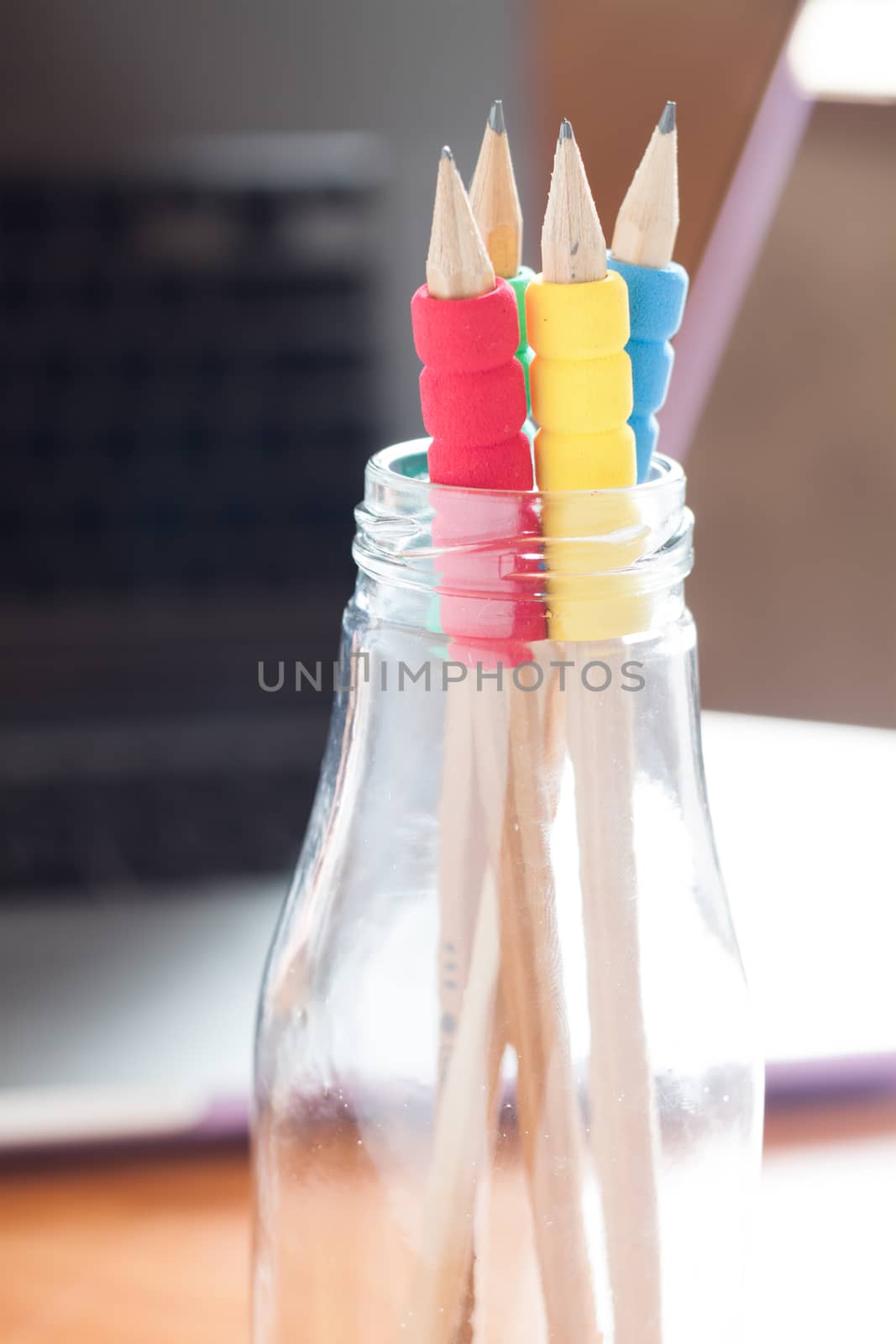 Pencils in bottle with blurred background, stock photo