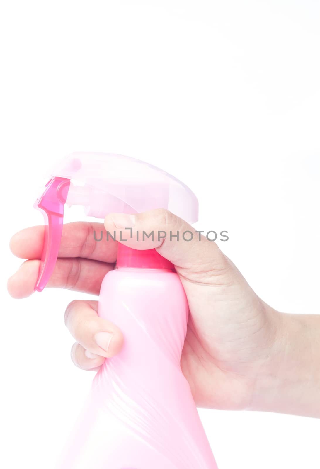 Hand holding plastic foggy spray bottle isolated on white background, stock photo