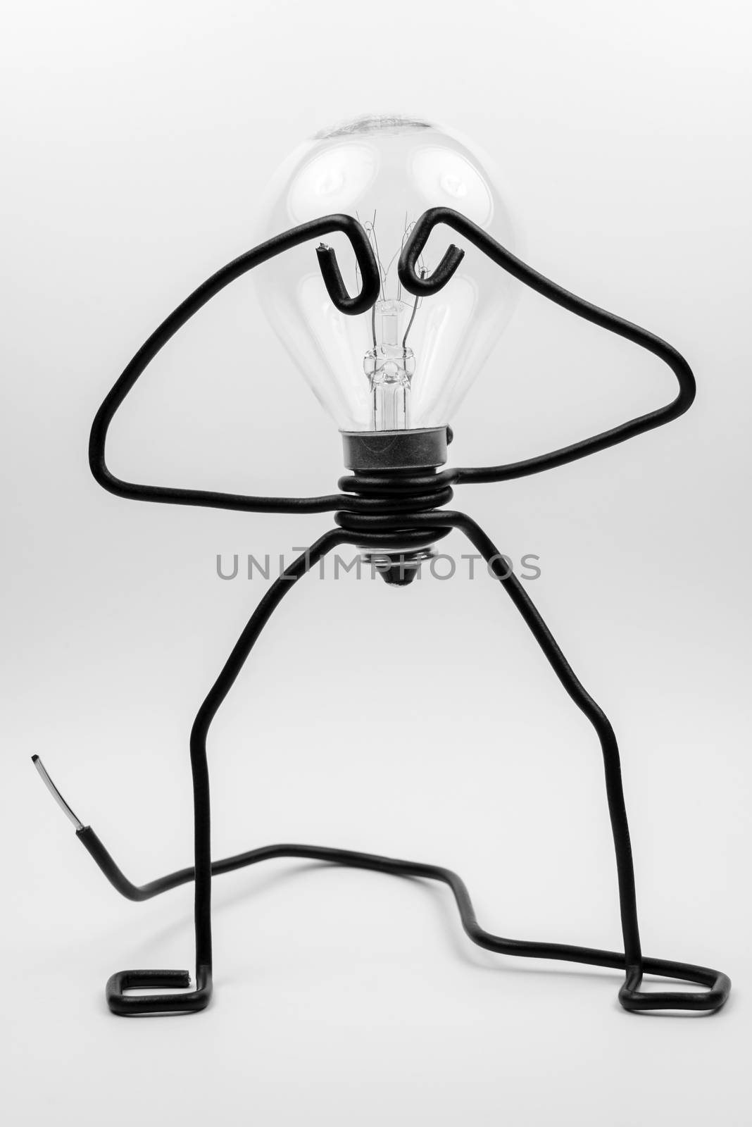 Emotional fantasy figure of a transparant light bulb and black electrical wires
