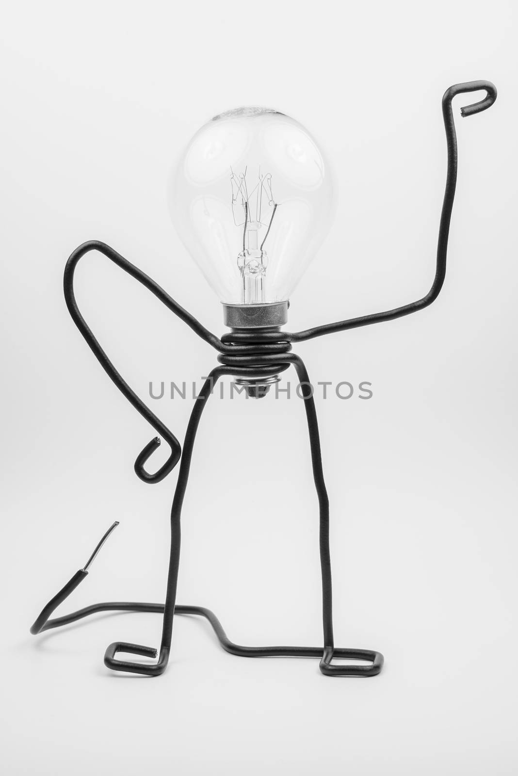 Emotional fantasy figure of a transparant light bulb and black electrical wires
