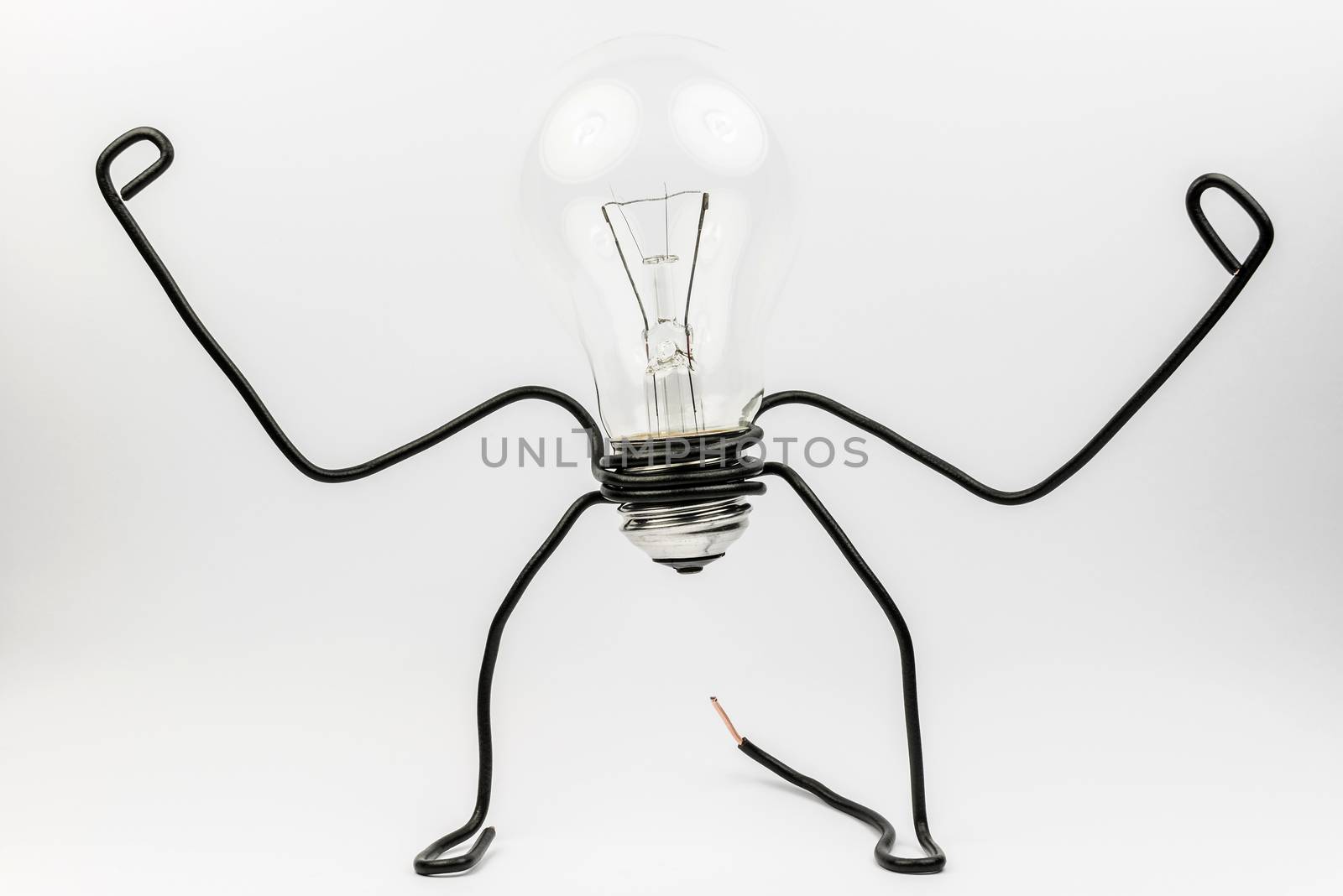 Emotional fantasy figure of a transparant light bulb and black electrical wires
