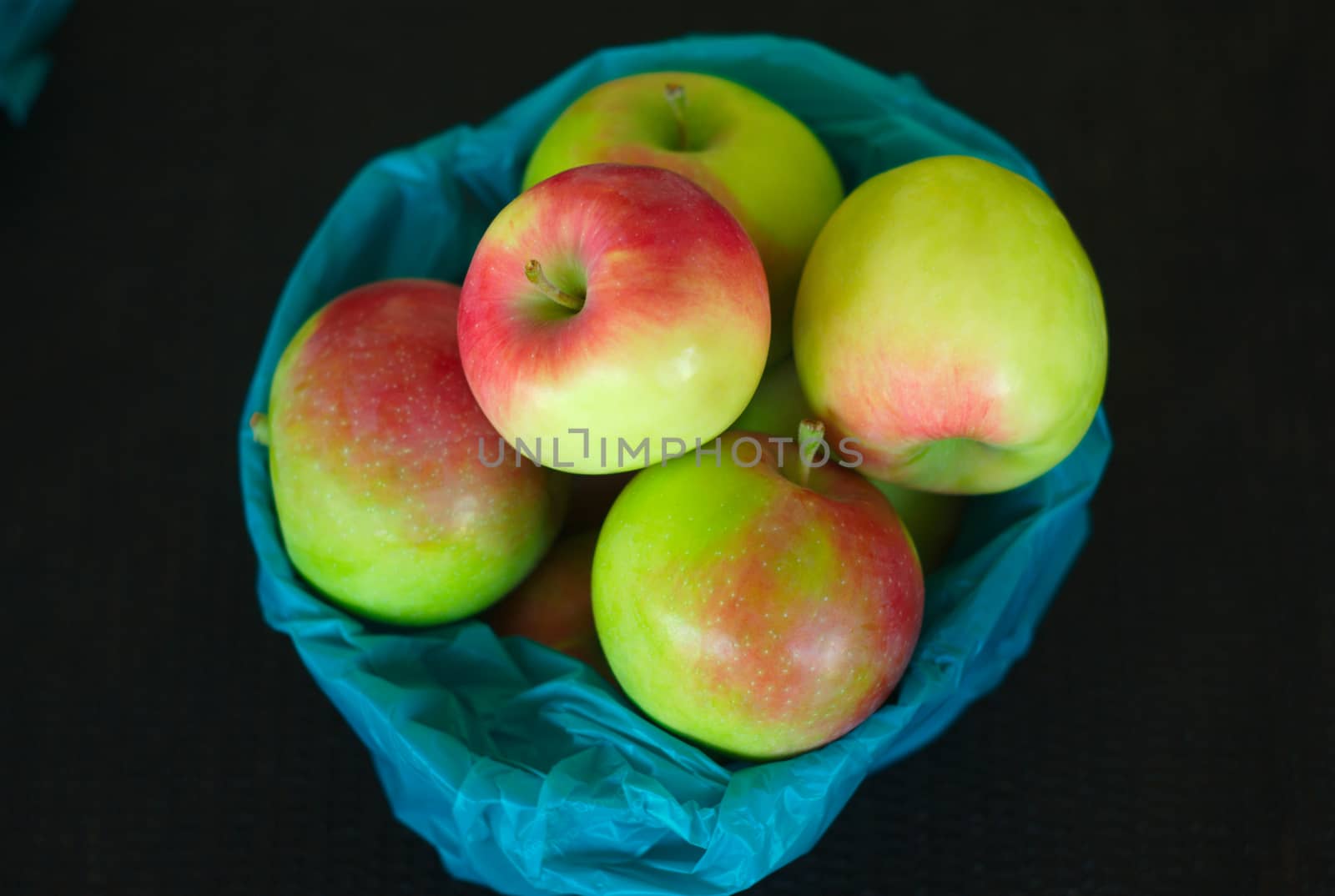 apples basket at the market dark black background