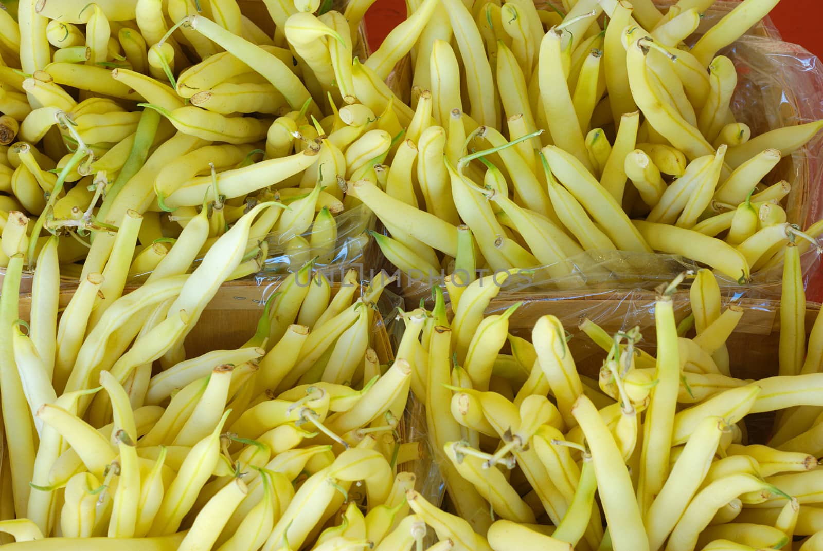 yellow beans at the market top view in baskets