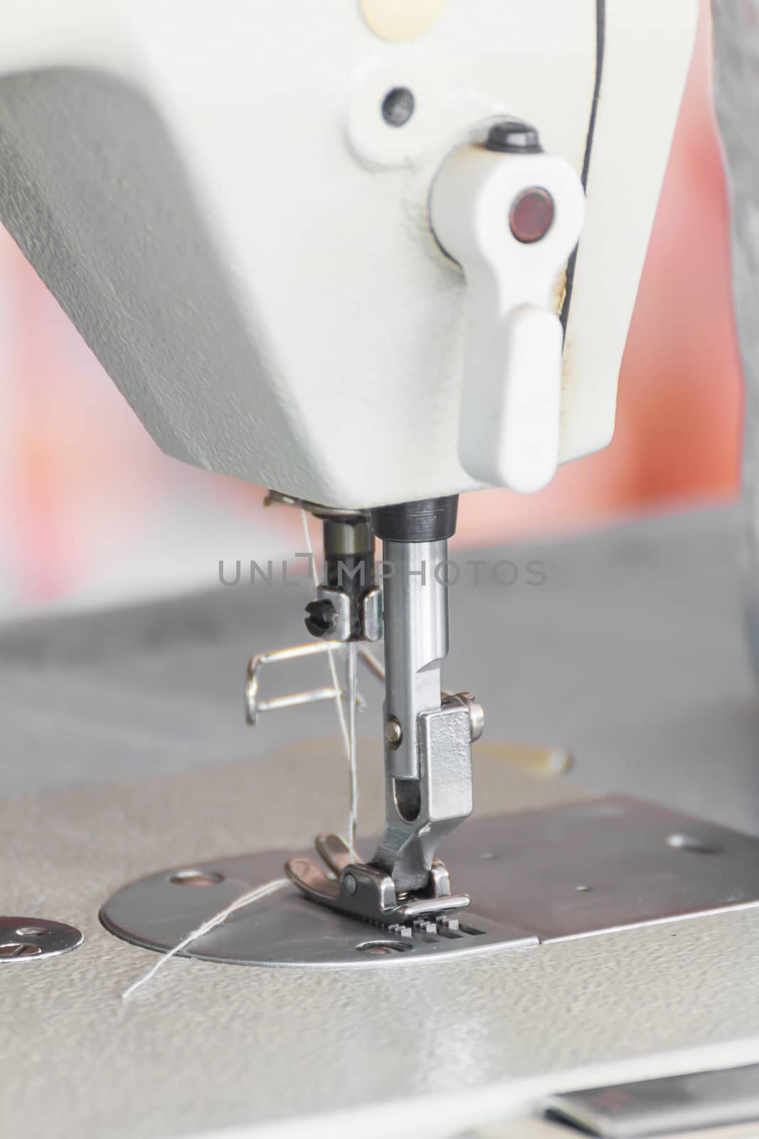 Close up industrial sewing machine by stoonn