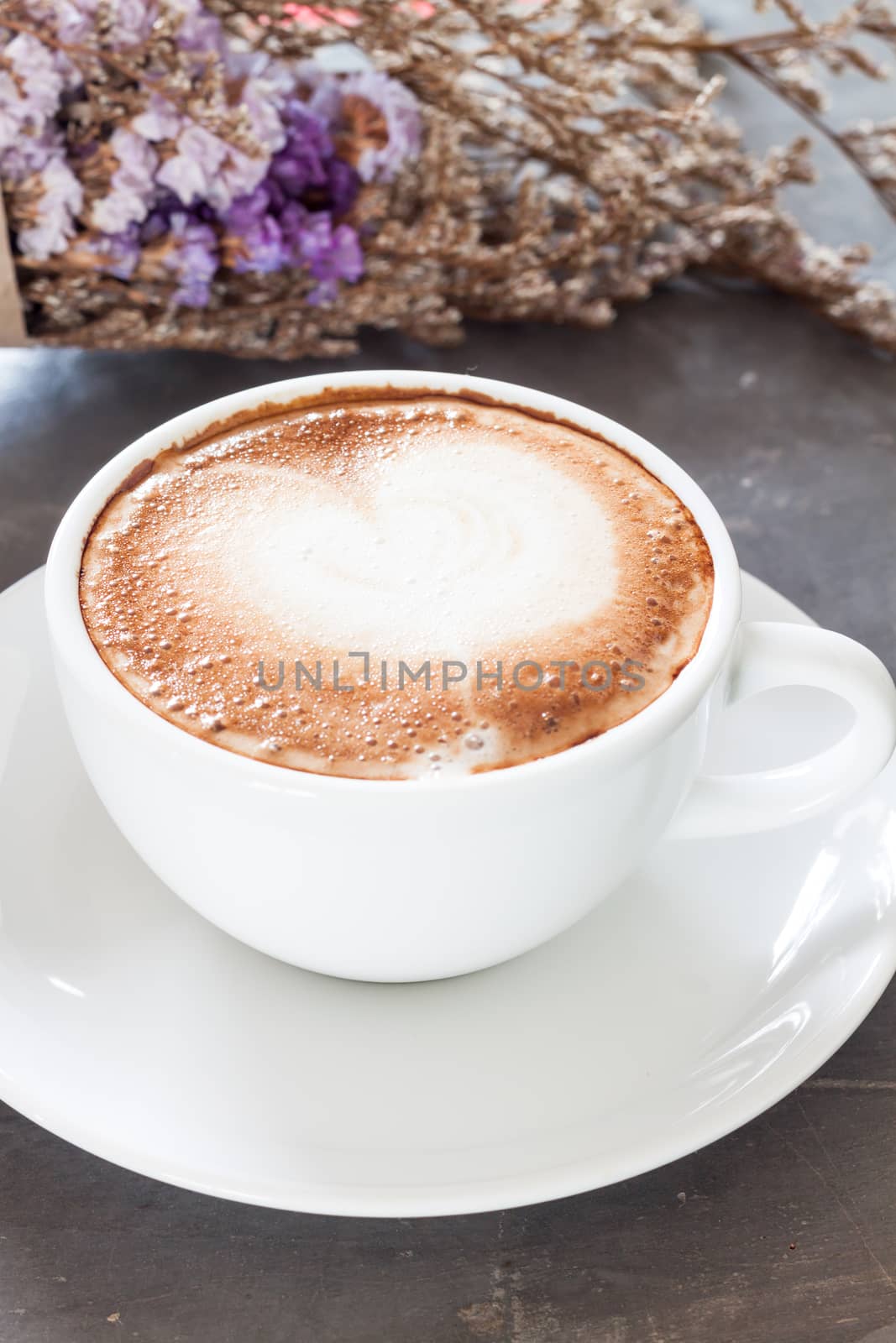 Coffee cup with beautiful violet flower, stock photo