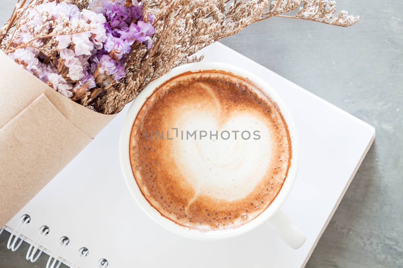 Coffee cup with beautiful violet flower, stock photo