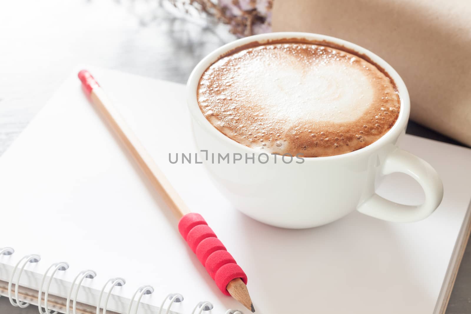 Coffee cup with notepad on grey background, stock photo