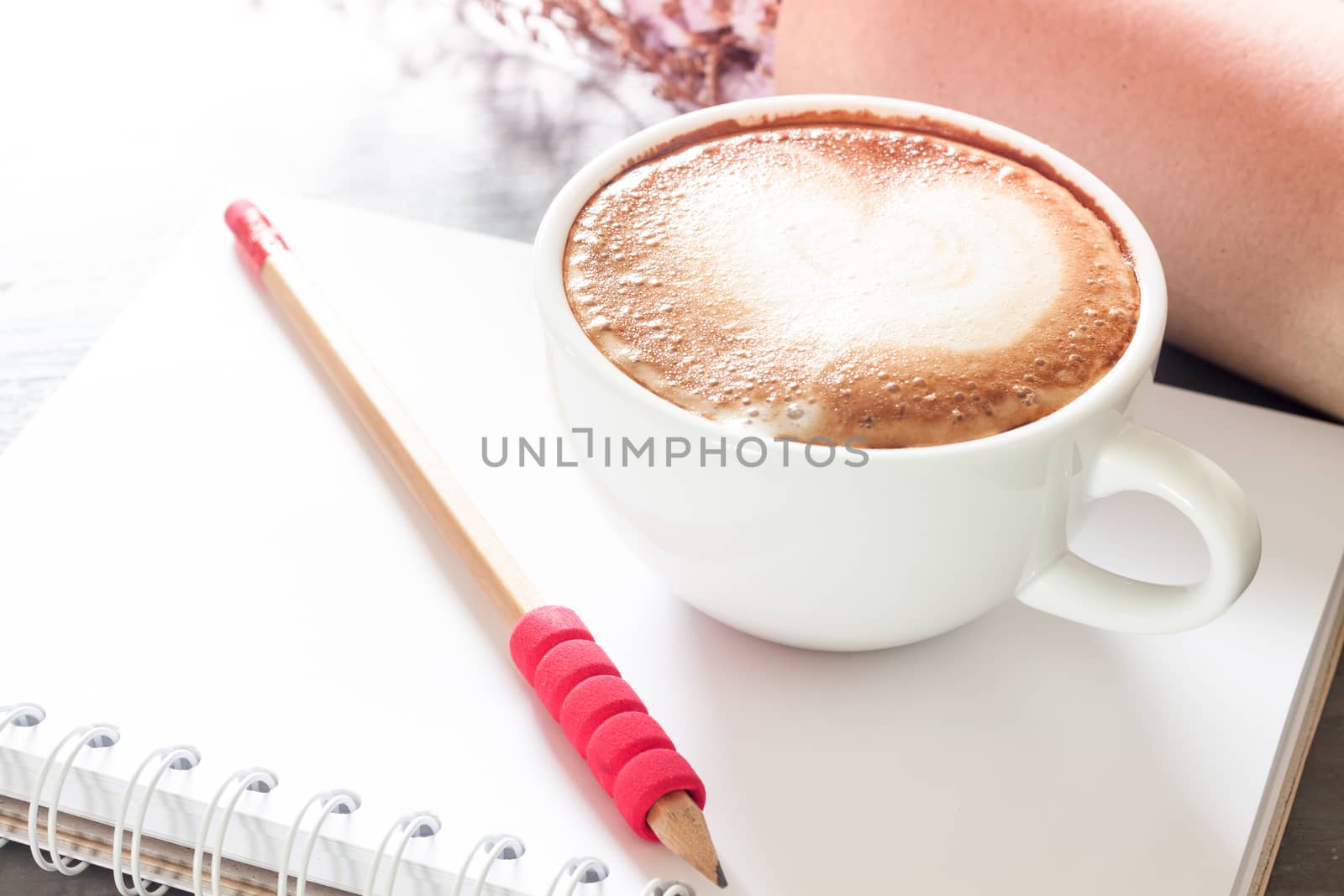 Coffee cup with notepad on grey background, stock photo