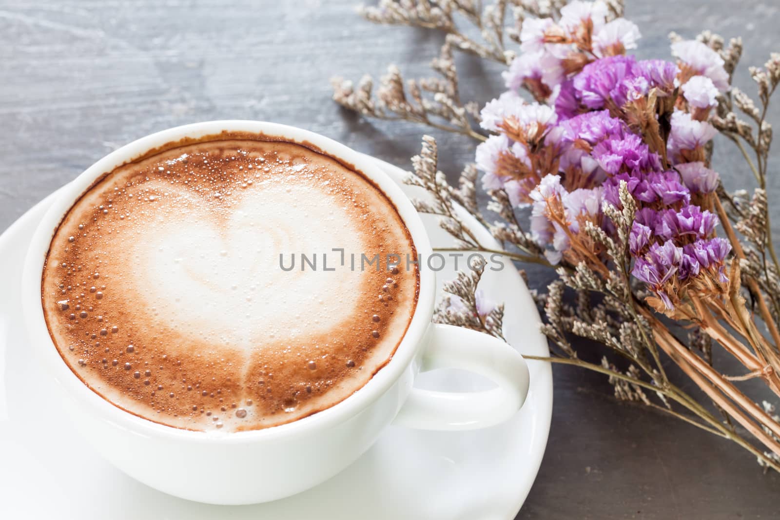 Coffee cup with beautiful violet flower, stock photo