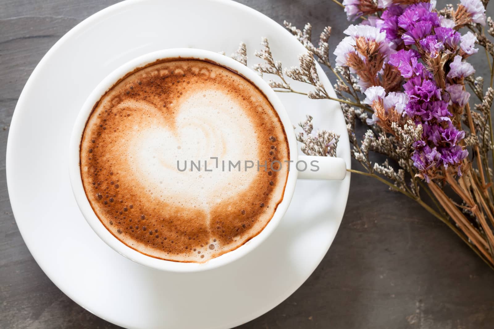 Coffee cup with beautiful violet flower, stock photo