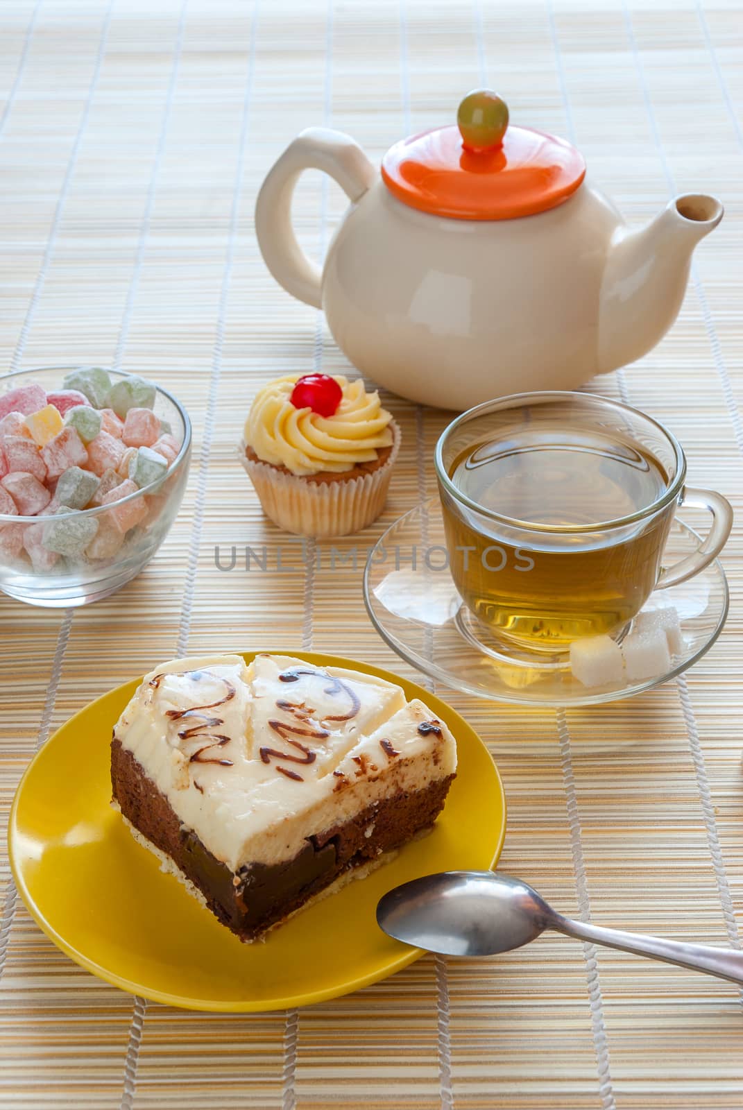 Green tea, fresh cherry muffin, cake on plate and colorful delight, various sweet dessert