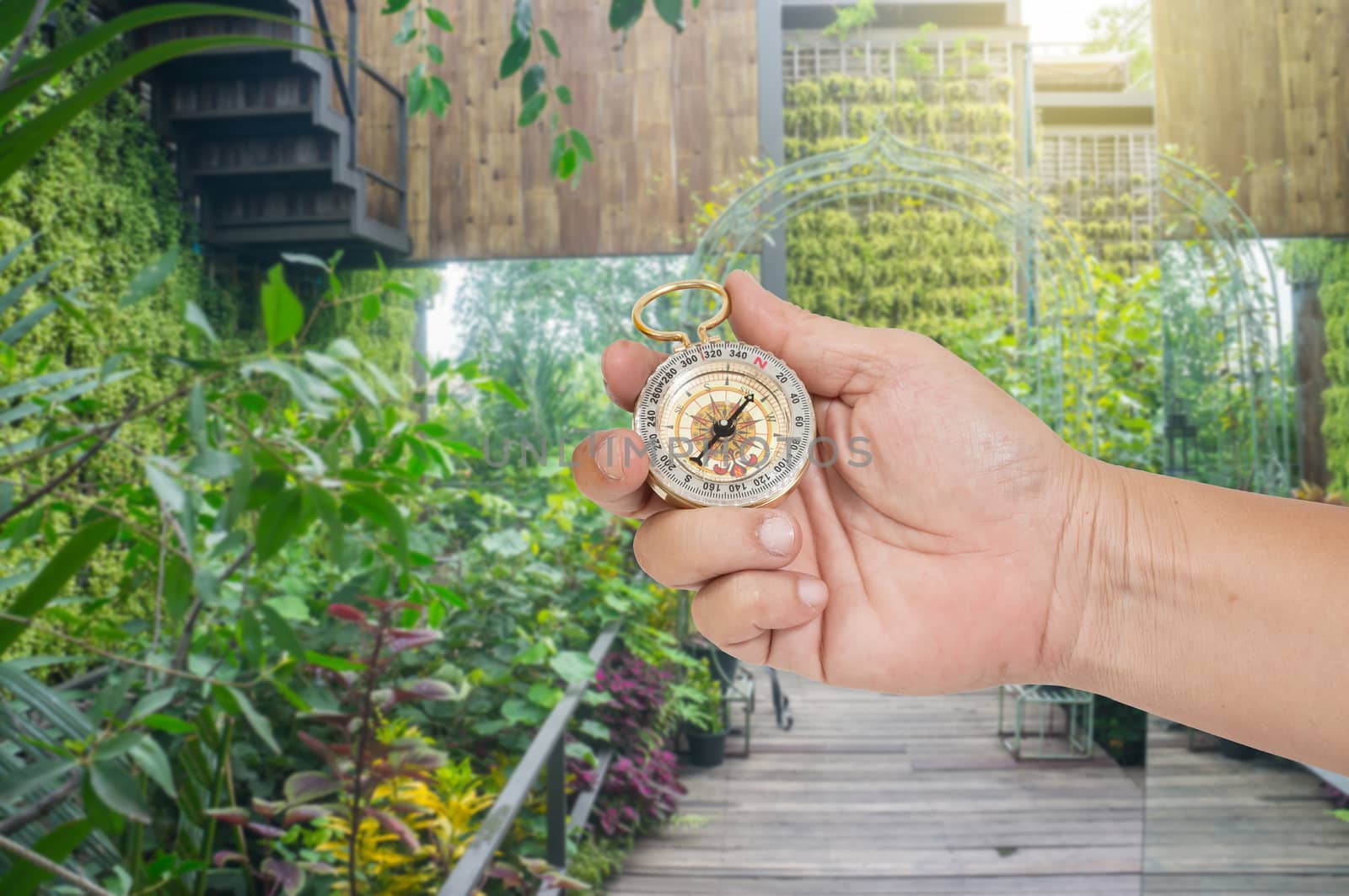 man holding compass in hand