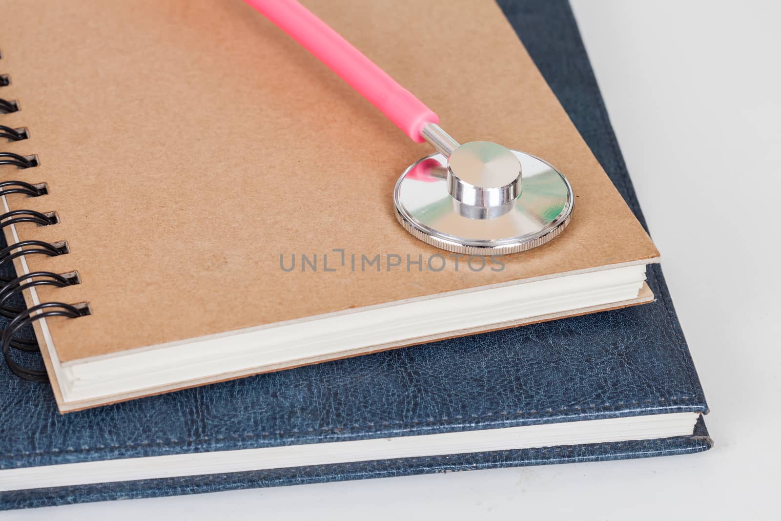 Diary  and stethoscope isolated on white background