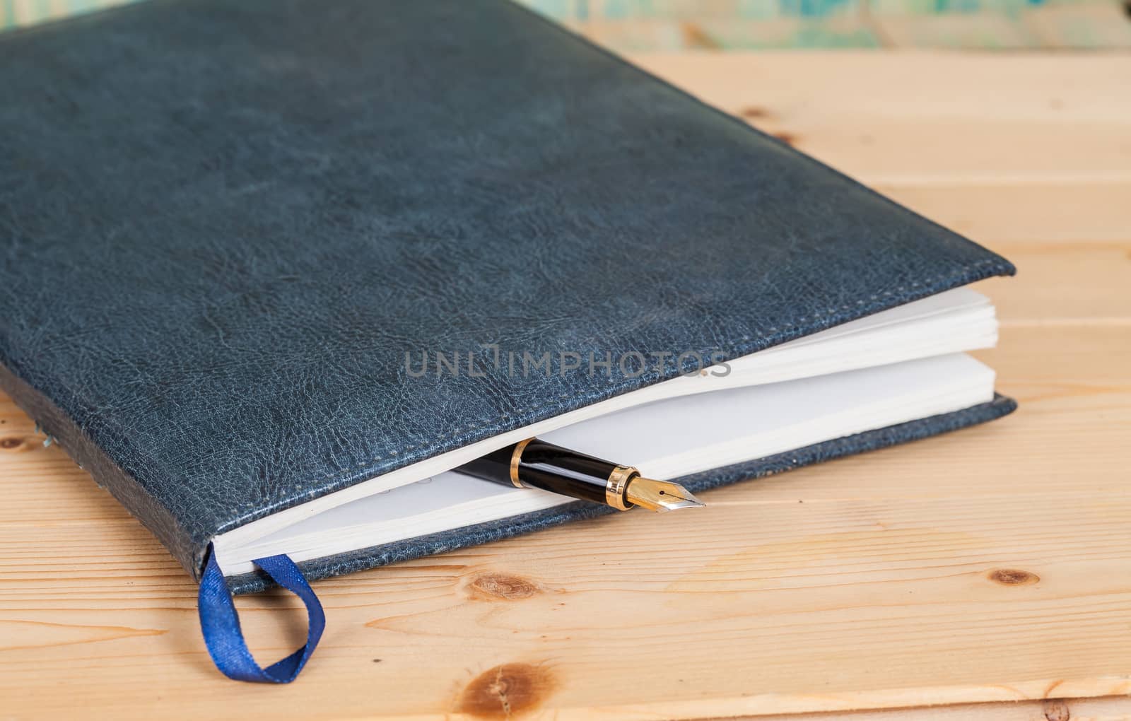 selective focus of the  pen on opened lined diary book , 
extremely shallow DOF
