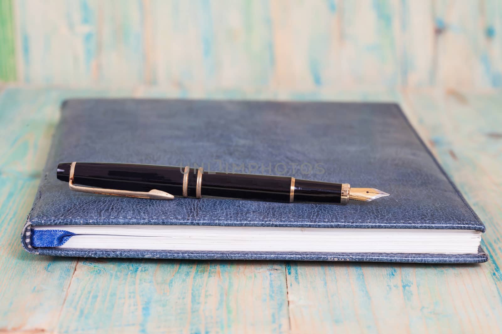 Diary with  pen  on wood background