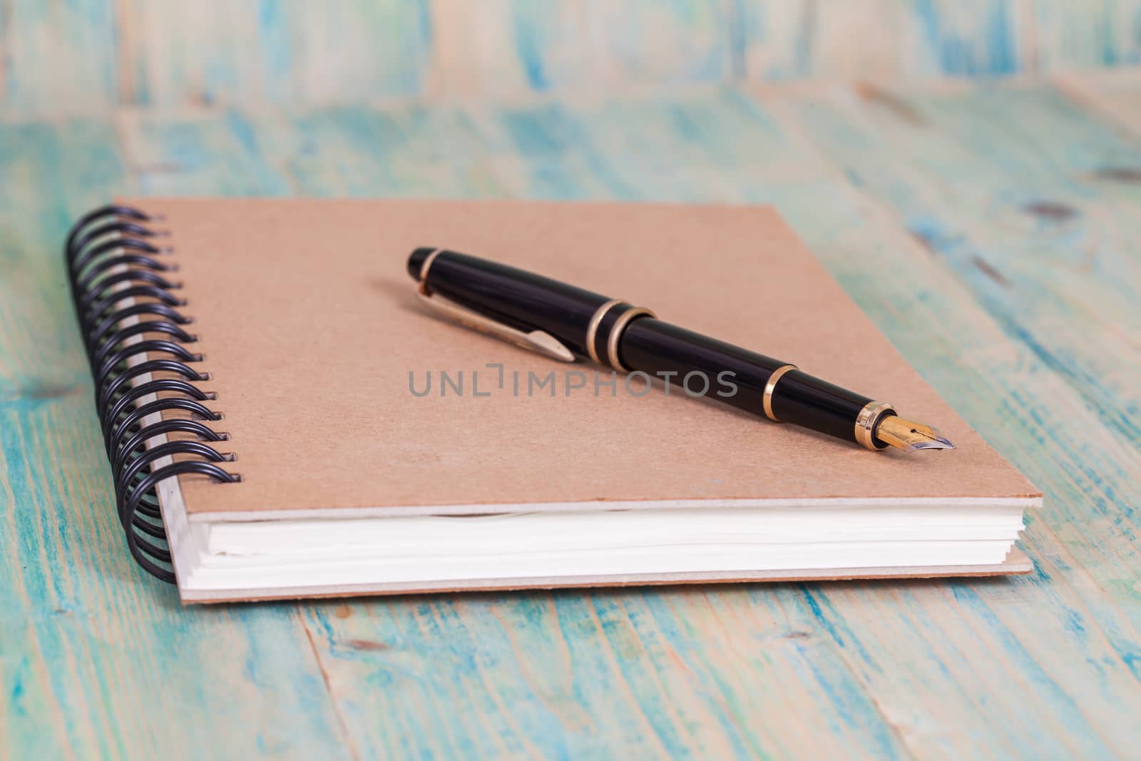 Diary with  pen  on wood background