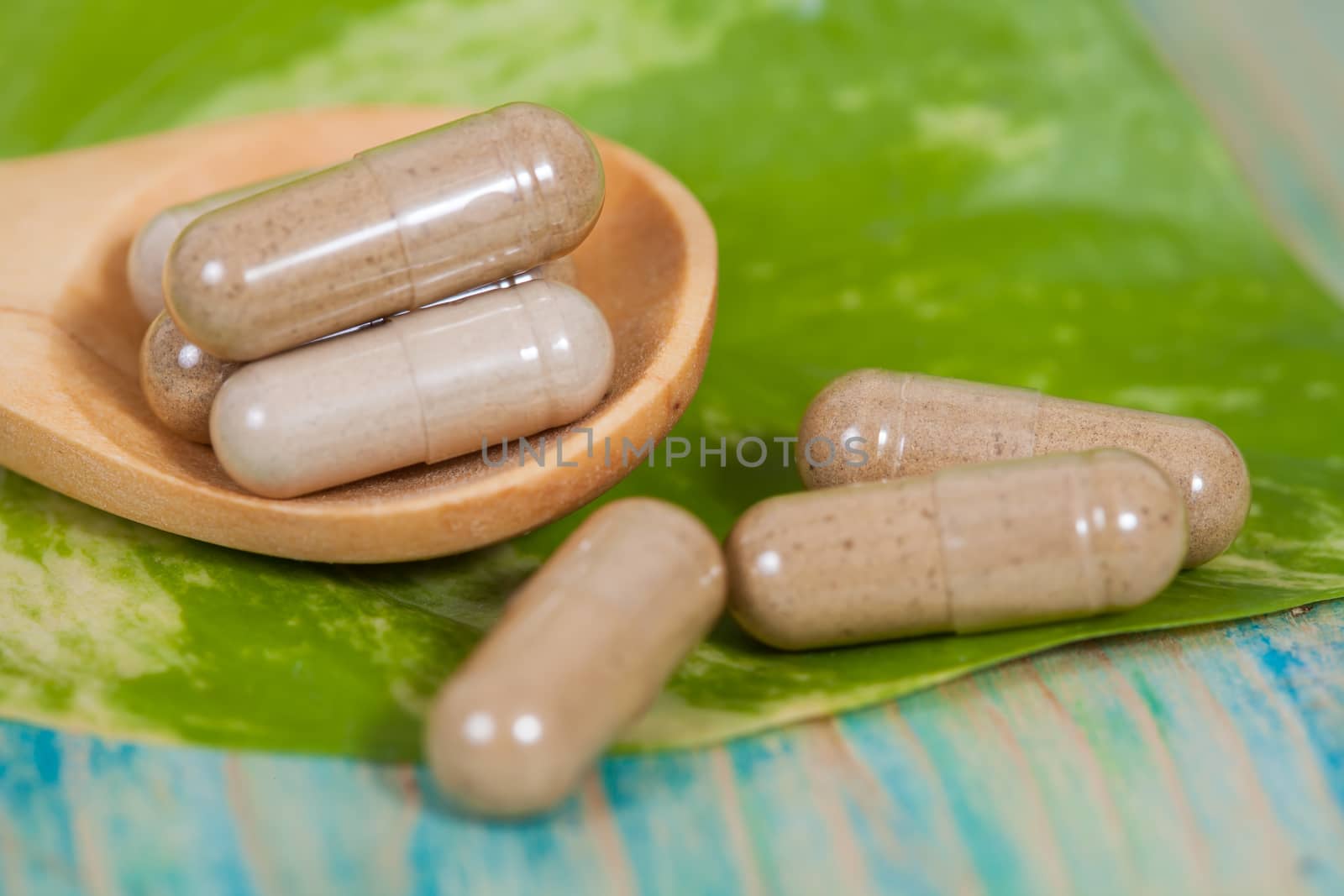 Capsules of herbs on spoon. healthy eating for healthy living. by amnarj2006