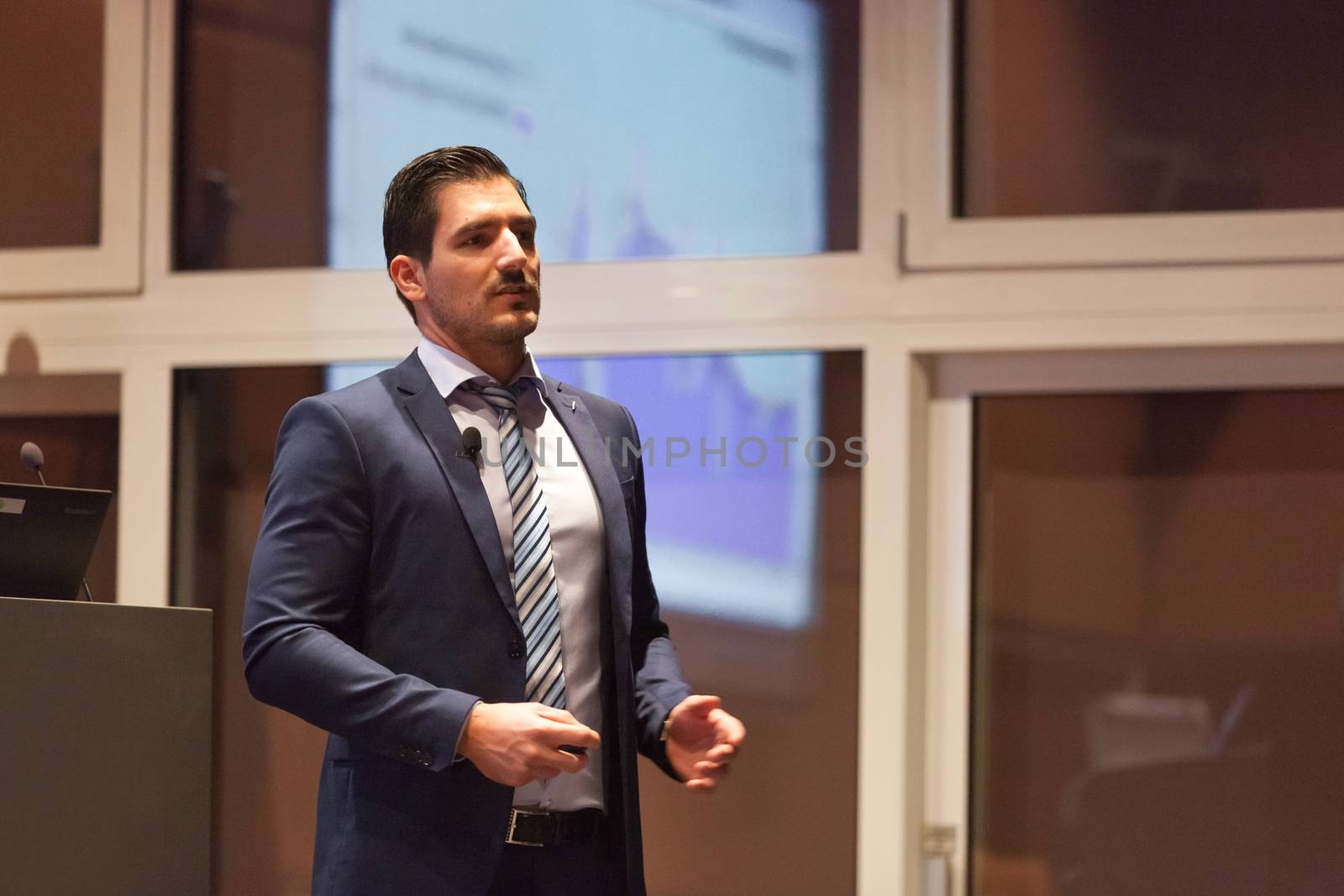 Speaker giving talk on podium at Business Conference. Entrepreneurship club. Horizontal composition.