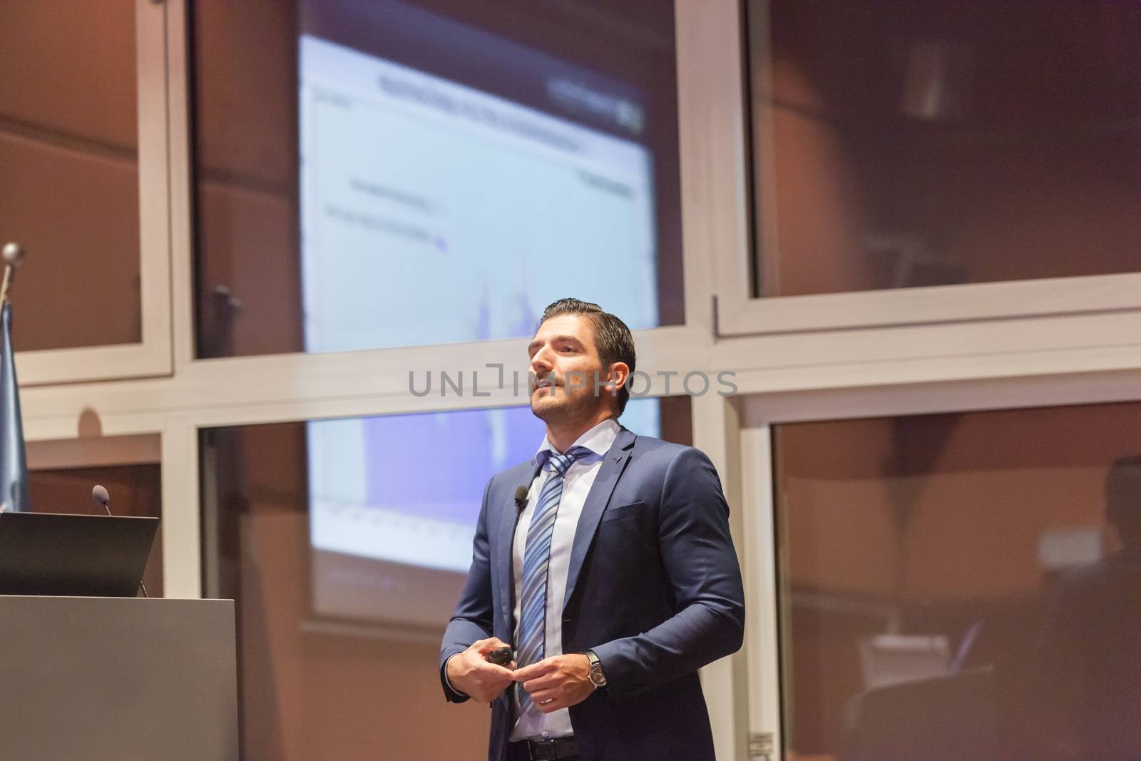 Speaker giving talk on podium at Business Conference. Entrepreneurship club. Horizontal composition.