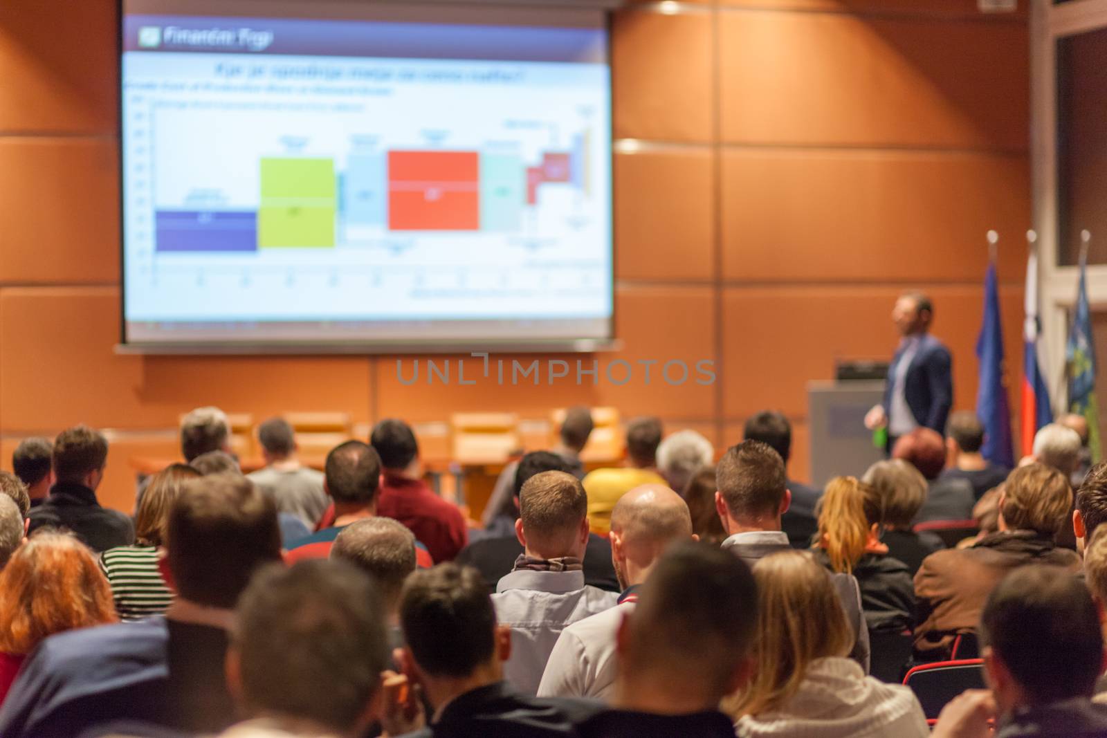 Speaker giving a talk in conference hall at business event. Audience at the conference hall. Business and Entrepreneurship concept.