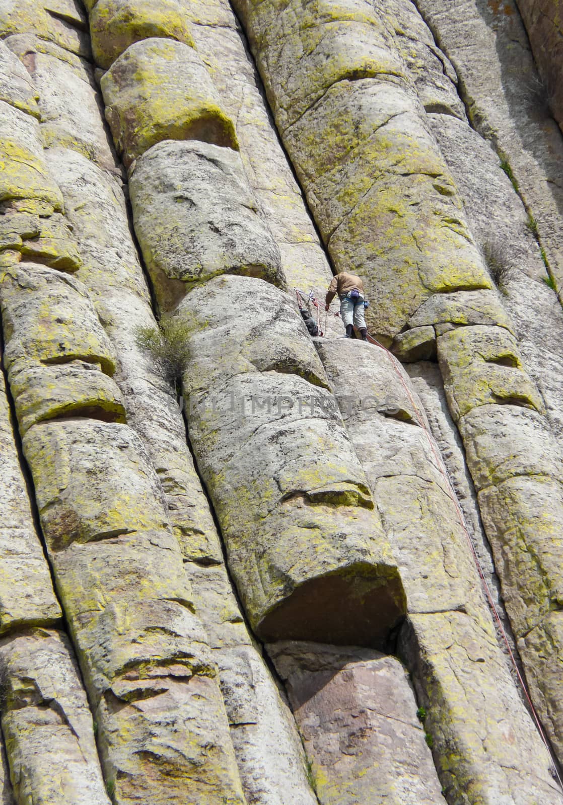 Devils Tower, Wyoming, USA - May 11, 2008: Man climbing on the wall of famous mountain Devils Tower in the Black Hills (Wyoming).