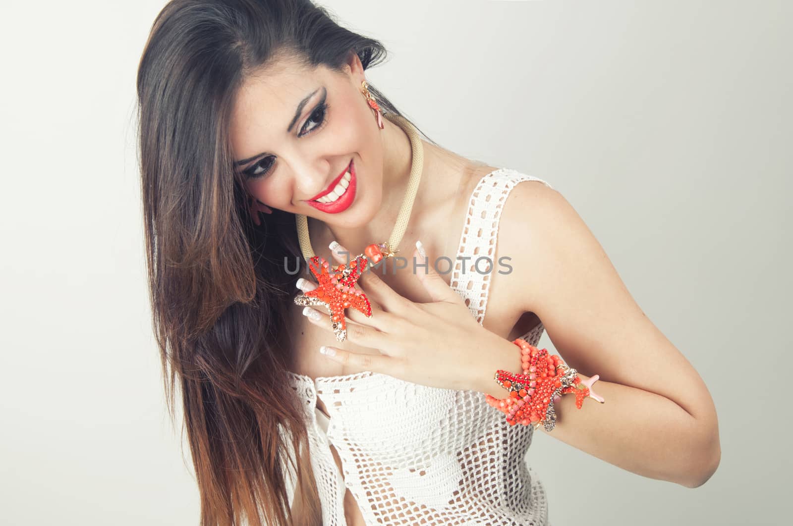 Woman smiling with perfect smile wearing  jewlry