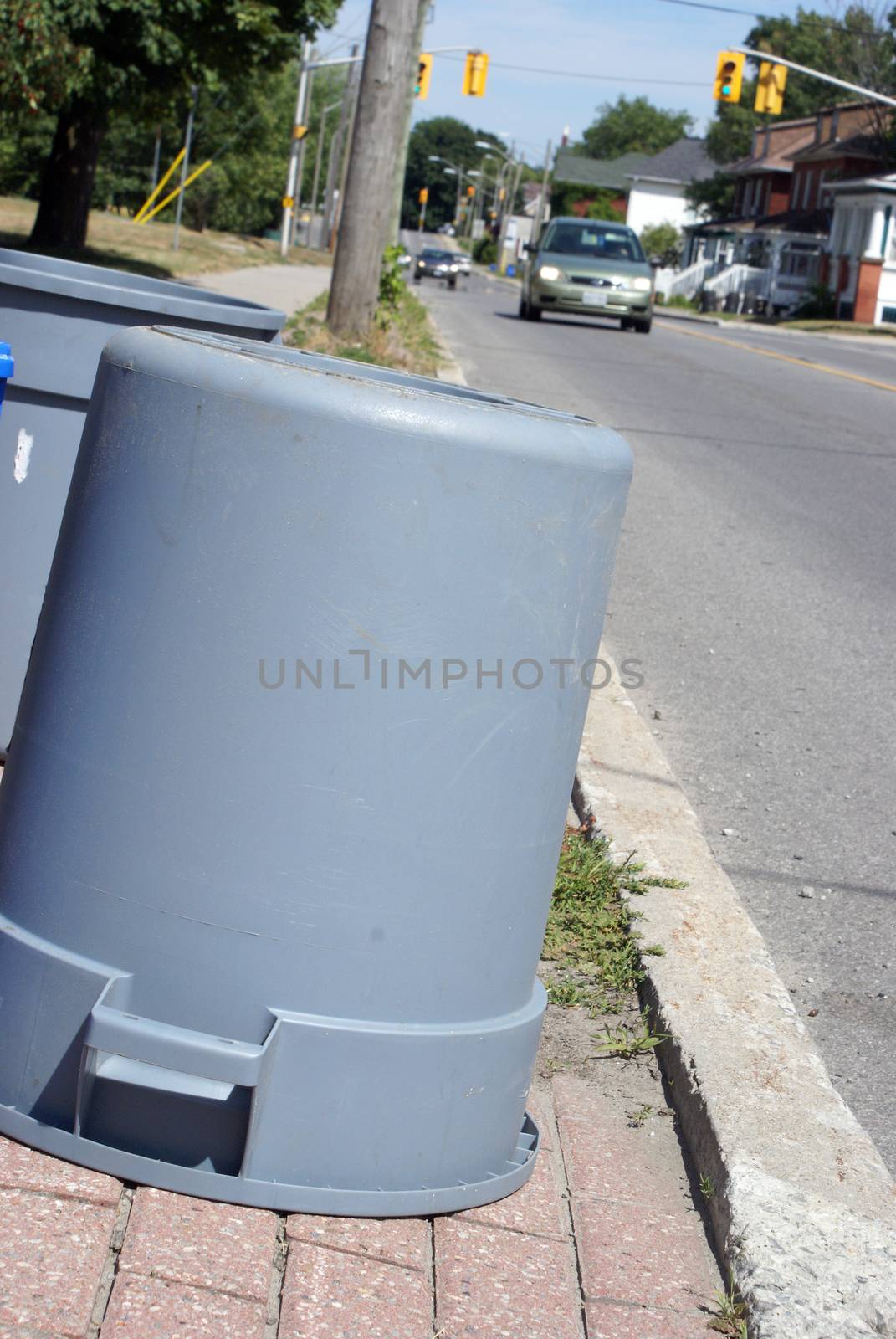 A closeup view of some garbage cans for the weekly trash pickup.