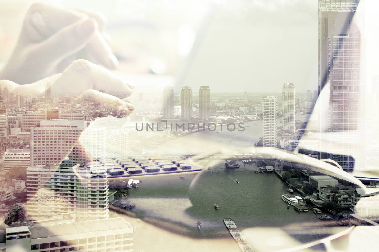 Double exposure image of woman using computer and cityscape background,Computer networking concept.